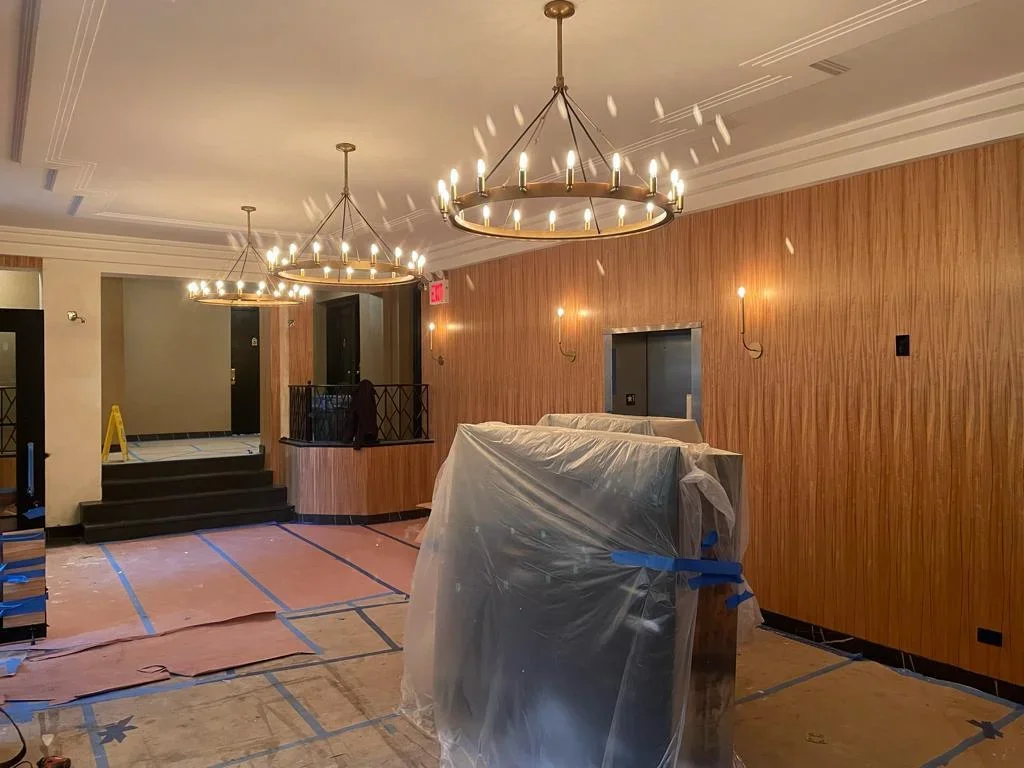 Commercial HVAC installation in ballroom with pendant lights and wood paneling