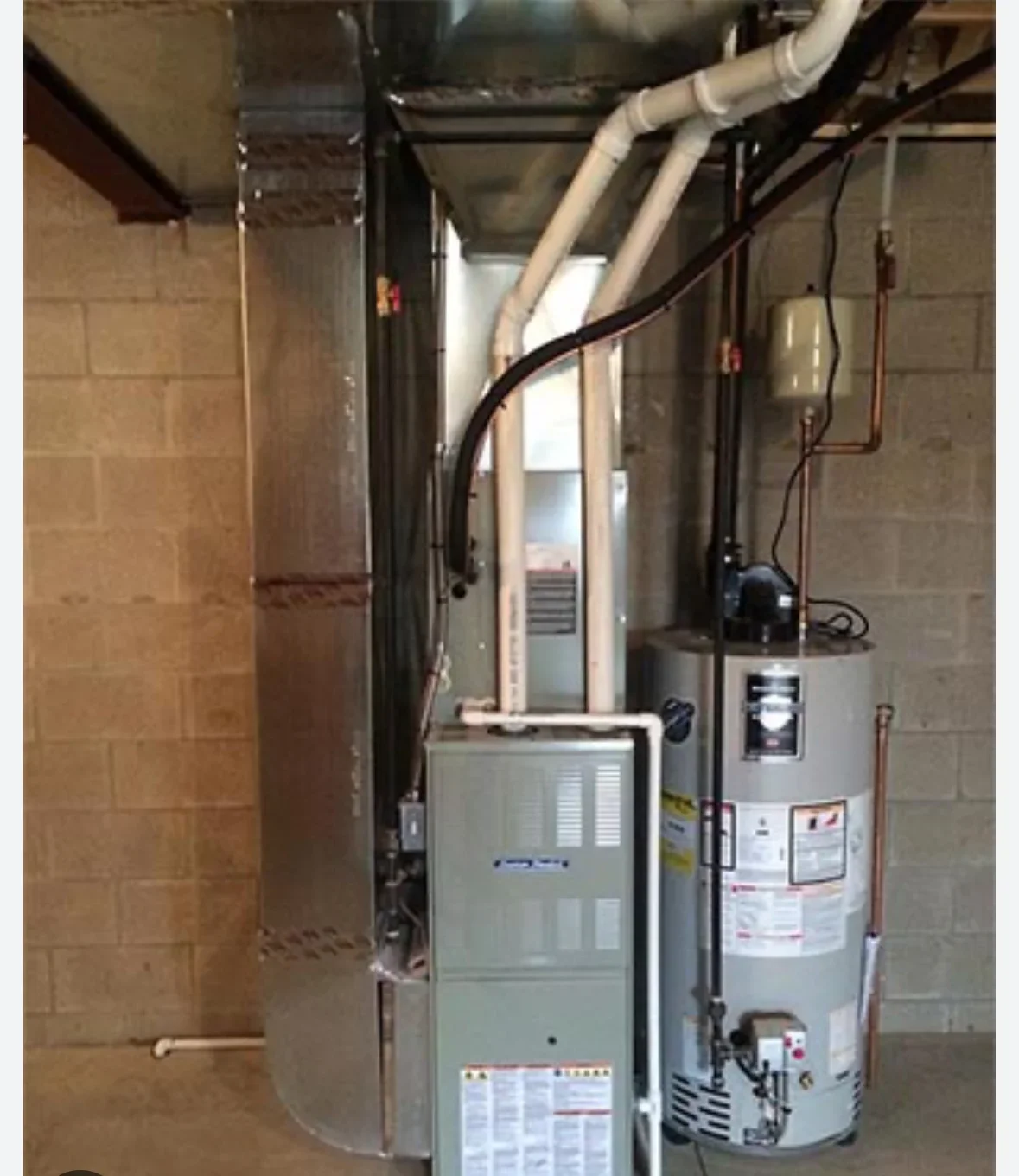 Furnace and water heater installation with ductwork and venting in basement