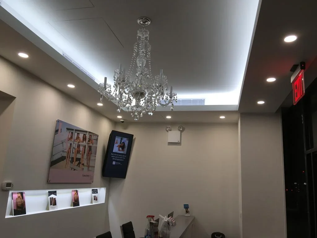 Modern commercial ceiling with LED lighting, crystal chandelier, and integrated HVAC system