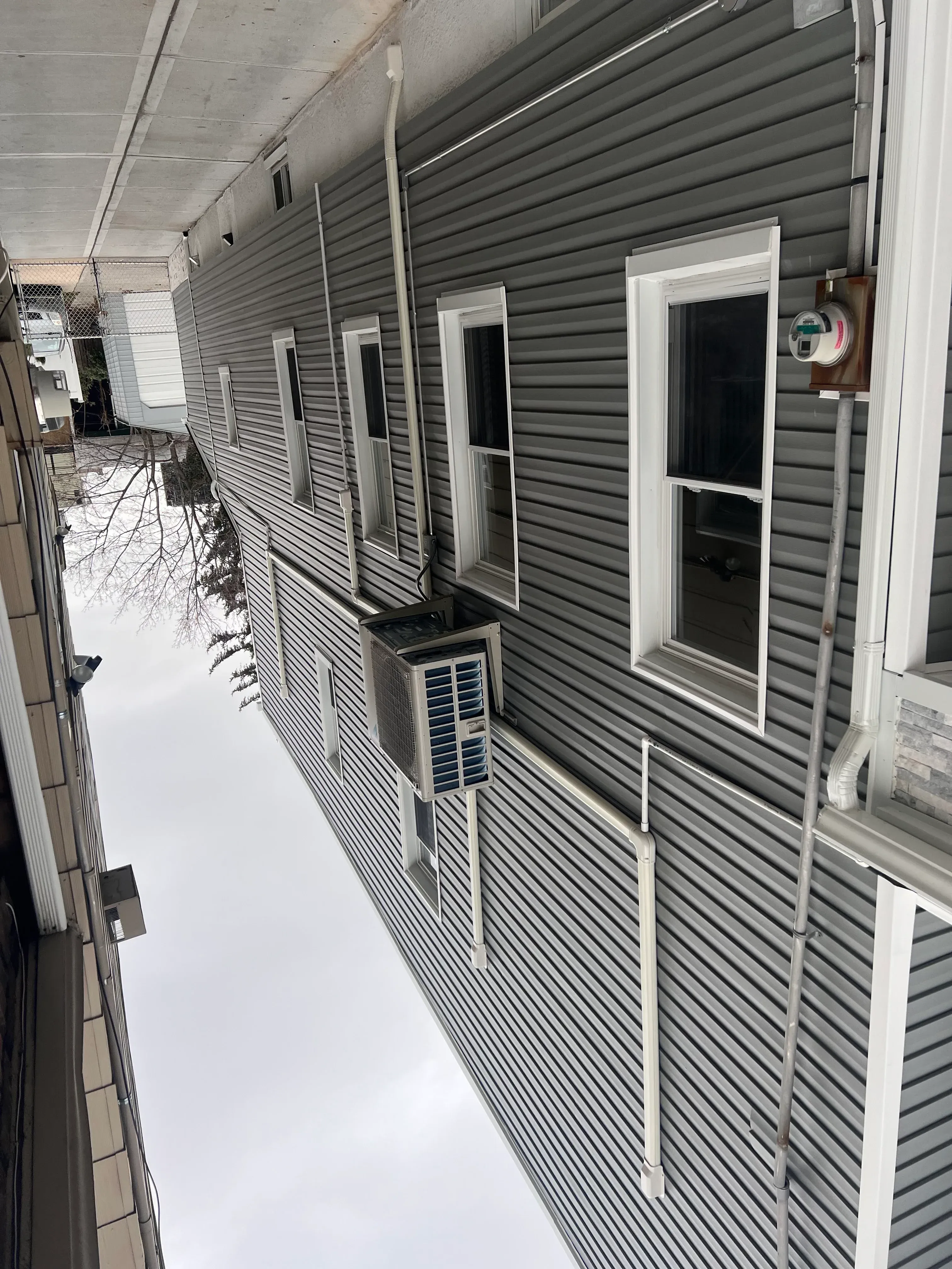 Metal standing seam roof with white trim, HVAC vents, and integrated mechanical systems