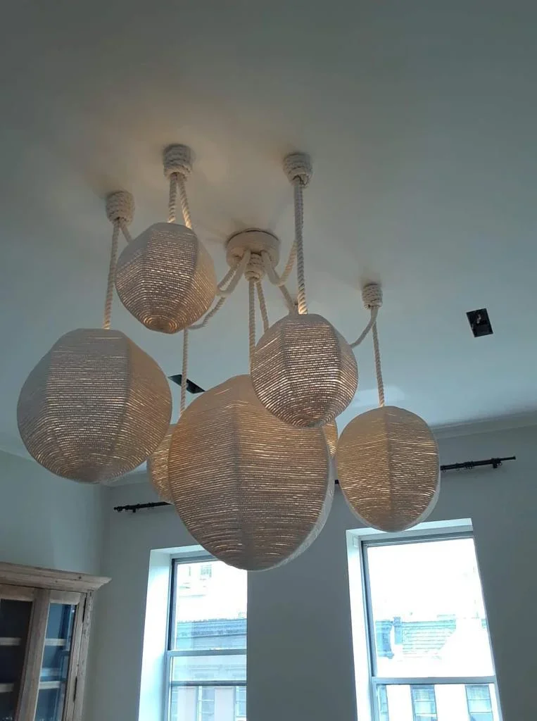 Multi-pendant woven light fixture with rope suspension installed on ceiling