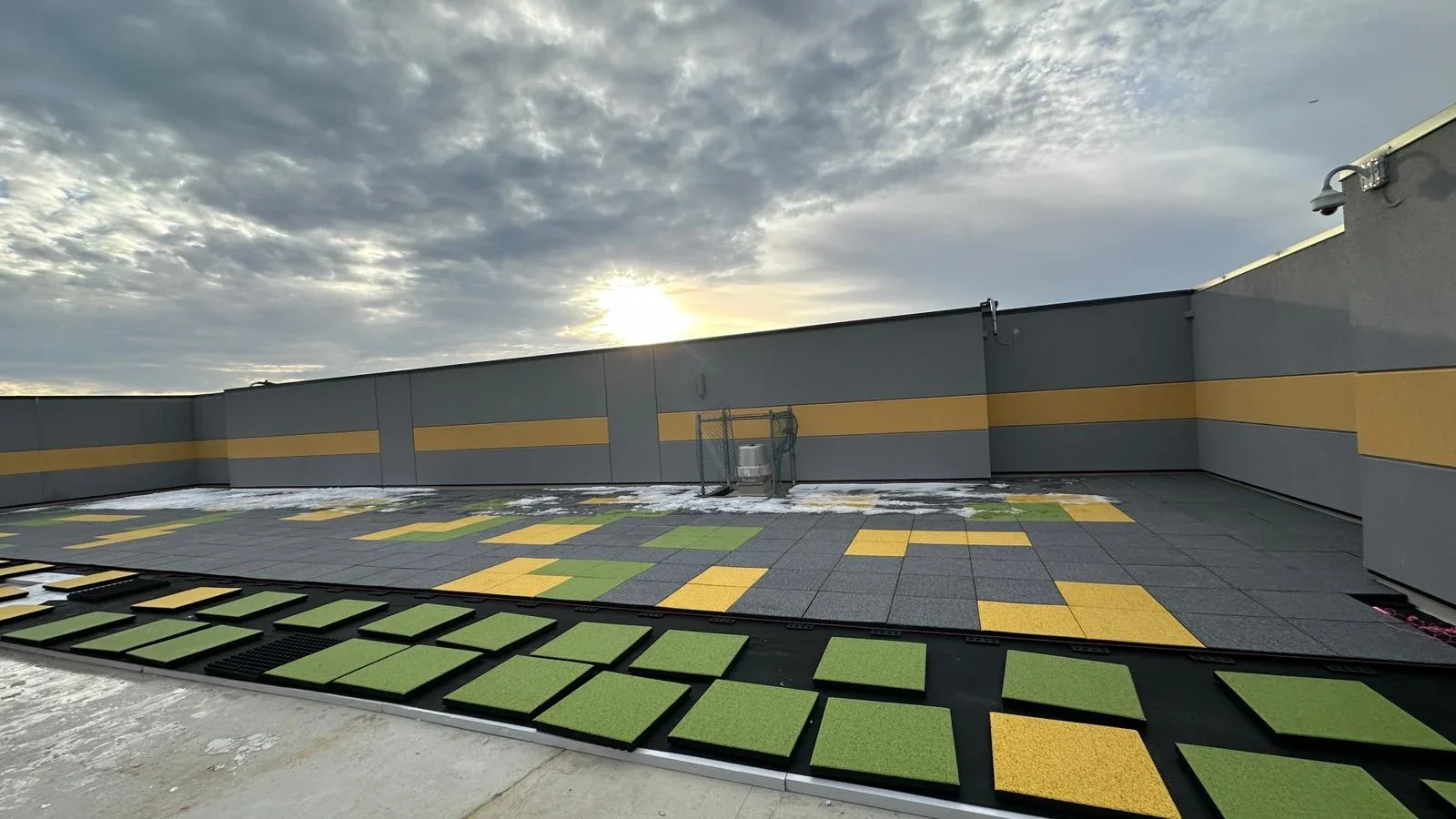 Commercial rooftop with yellow and green modular decking and HVAC equipment installation